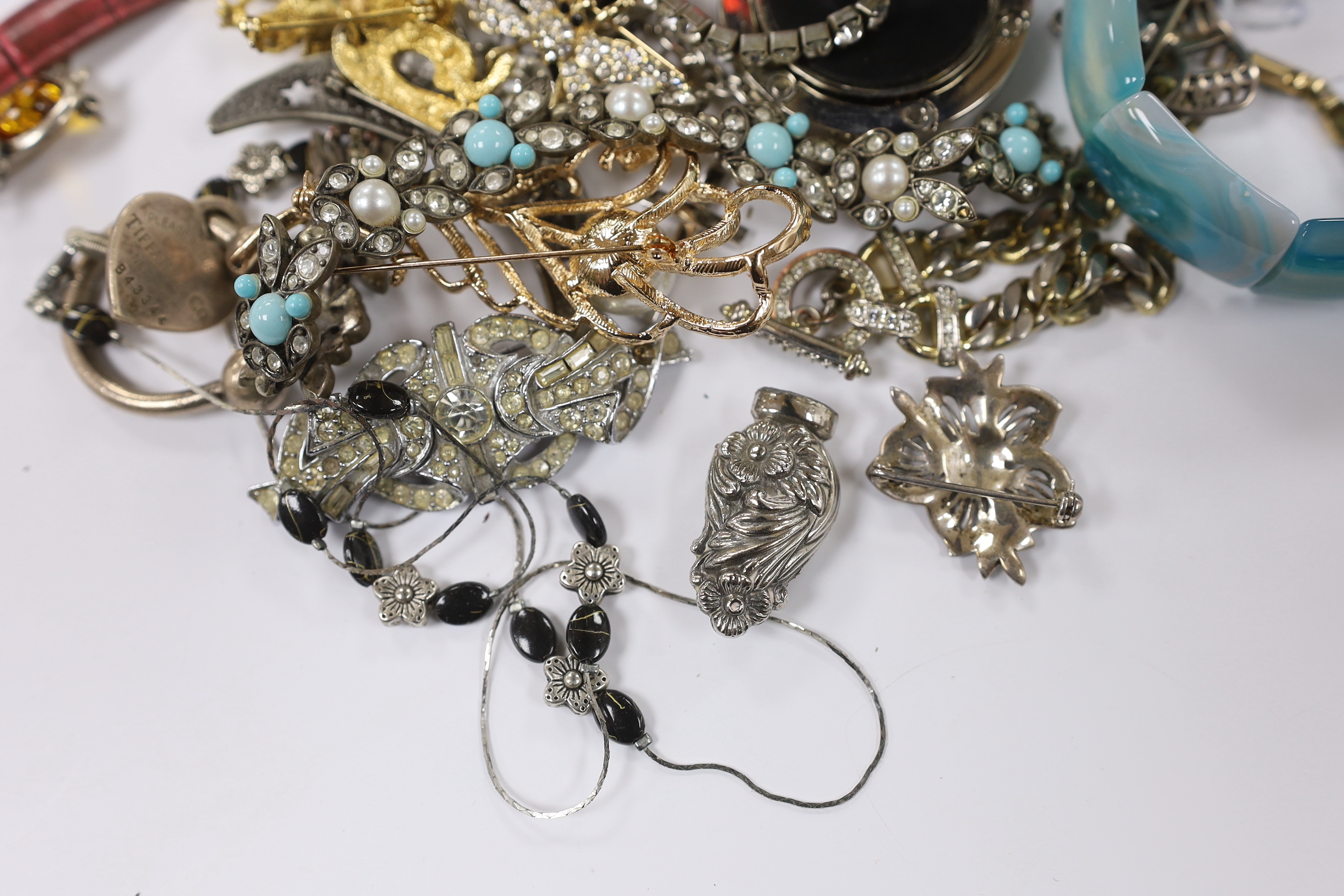 A group of assorted costume jewellery including marcasite and paste set, a Tiffany & Co sterling key ring, a 925 and amber set elephant brooch, blue agate bracelet, wrist watches, travelling watch, etc.